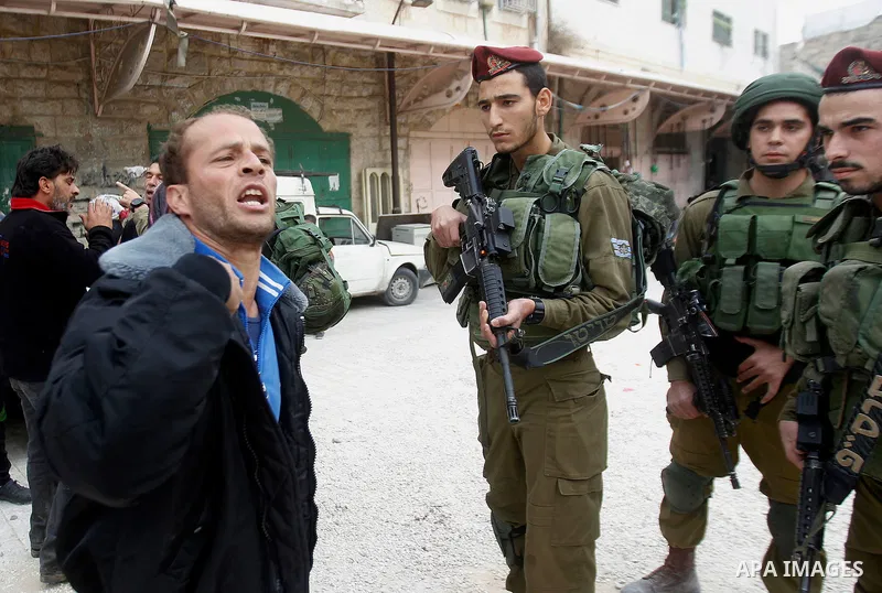 A Palestinian man scuffles with Israeli security forces after arrested two Palestinian youths, charges throw stones towards Israeli soldiers, in the West Bank city of Hebron, on Nov. 16, 2016. Photo by Wisam Hashlamoun
