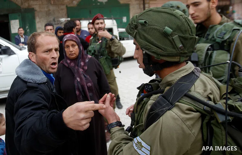 A Palestinian man scuffles with Israeli security forces after arrested two Palestinian youths, charges throw stones towards Israeli soldiers, in the West Bank city of Hebron, on Nov. 16, 2016. Photo by Wisam Hashlamoun