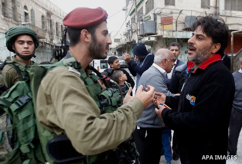 A Palestinian man scuffles with Israeli security forces after arrested two Palestinian youths, charges throw stones towards Israeli soldiers, in the West Bank city of Hebron, on Nov. 16, 2016. Photo by Wisam Hashlamoun