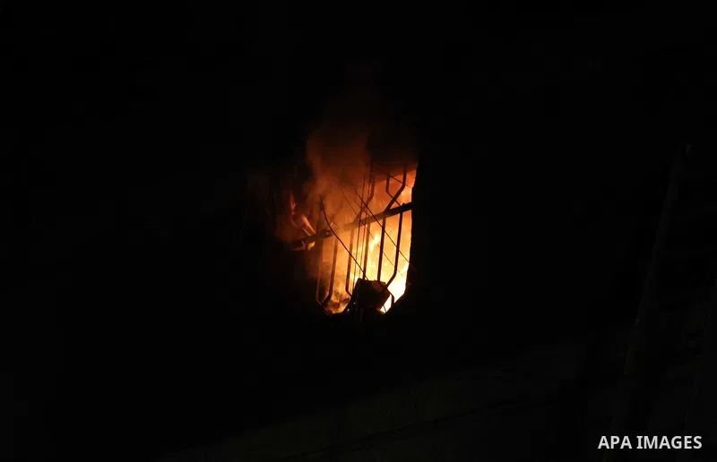 Egyptians gather as Civil defense firefighters effort to control a fire that broke out in a store in the Fagala district of Cairo on November 16, 2016. Photo by Amr Sayed