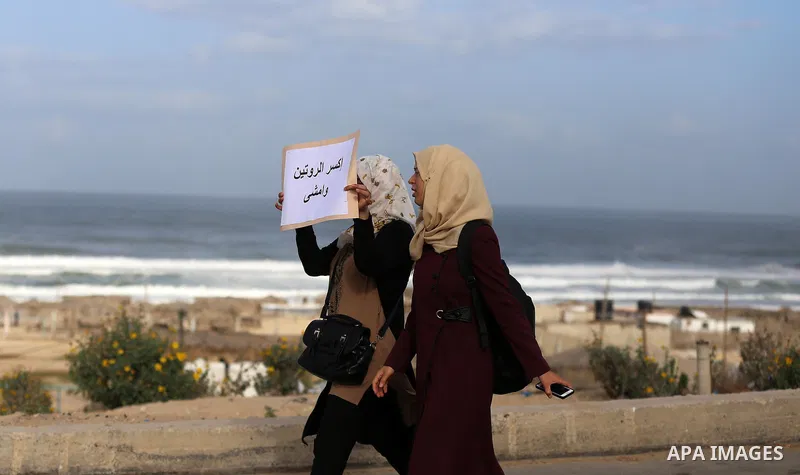 Palestinian women march on a street, calling for the rehabilitation of marginalised women in Gaza City on November 17, 2016. Photo by Yasser Qudih
