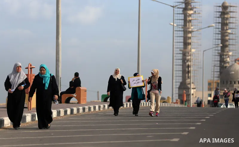 Palestinian women march on a street, calling for the rehabilitation of marginalised women in Gaza City on November 17, 2016. Photo by Yasser Qudih