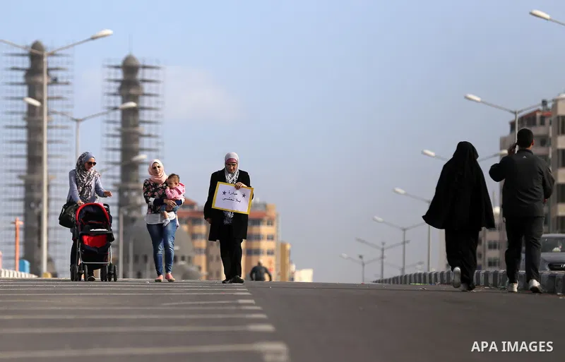 Palestinian women march on a street, calling for the rehabilitation of marginalised women in Gaza City on November 17, 2016. Photo by Yasser Qudih