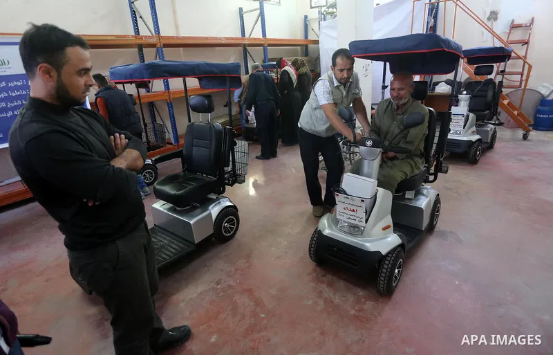 Palestinians with special needs receive electric cars financed by the Turkish humanitarian relief and freedoms IHH and Qatari Foundation Ruff, in Gaza City, on November 17, 2016. Photo by Mohammed Asad