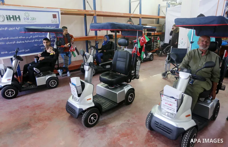 Palestinians with special needs receive electric cars financed by the Turkish humanitarian relief and freedoms IHH and Qatari Foundation Ruff, in Gaza City, on November 17, 2016. Photo by Mohammed Asad