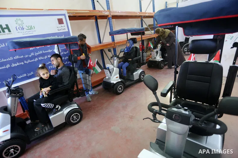 Palestinians with special needs receive electric cars financed by the Turkish humanitarian relief and freedoms IHH and Qatari Foundation Ruff, in Gaza City, on November 17, 2016. Photo by Mohammed Asad