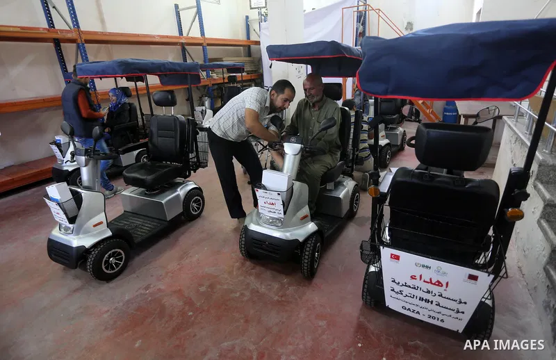 Palestinians with special needs receive electric cars financed by the Turkish humanitarian relief and freedoms IHH and Qatari Foundation Ruff, in Gaza City, on November 17, 2016. Photo by Mohammed Asad