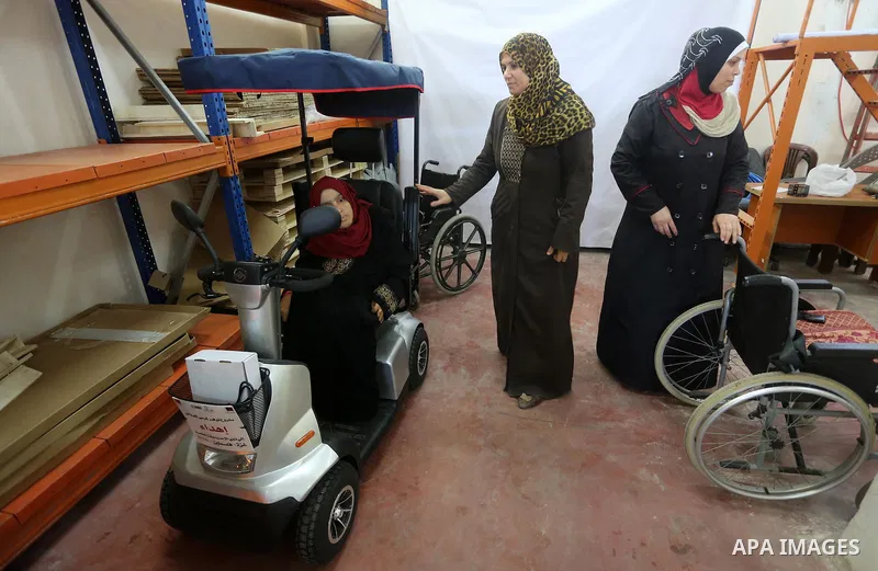 Palestinians with special needs receive electric cars financed by the Turkish humanitarian relief and freedoms IHH and Qatari Foundation Ruff, in Gaza City, on November 17, 2016. Photo by Mohammed Asad