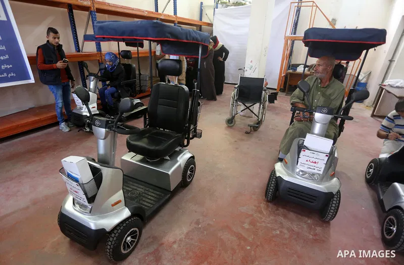 Palestinians with special needs receive electric cars financed by the Turkish humanitarian relief and freedoms IHH and Qatari Foundation Ruff, in Gaza City, on November 17, 2016. Photo by Mohammed Asad