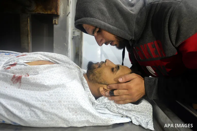A relative mourns over the body of Mohammed Abu Saada, a 26-year-old Palestinian man who was reportedly killed in clashes with the Israeli army along the Gaza border, at a morgue in Deir al-Balah in central Gaza on Novem...