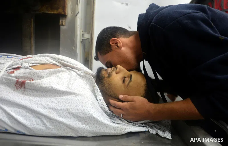 A relative mourns over the body of Mohammed Abu Saada, a 26-year-old Palestinian man who was reportedly killed in clashes with the Israeli army along the Gaza border, at a morgue in Deir al-Balah in central Gaza on Novem...