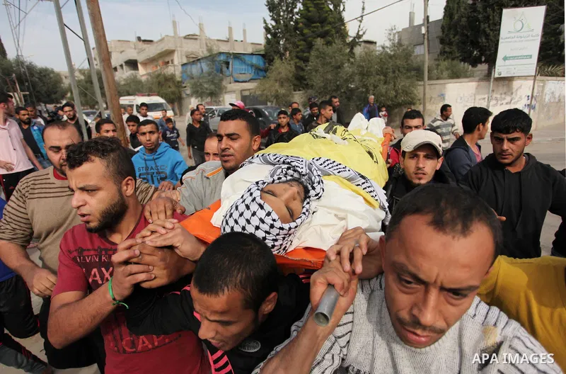 Mourners carry the body of Mohammed Abu Saada, a 26-year-old Palestinian man who was reportedly killed in clashes with the Israeli army along the Gaza border, during his funeral in the Nuseirat refugee camp in the centra...
