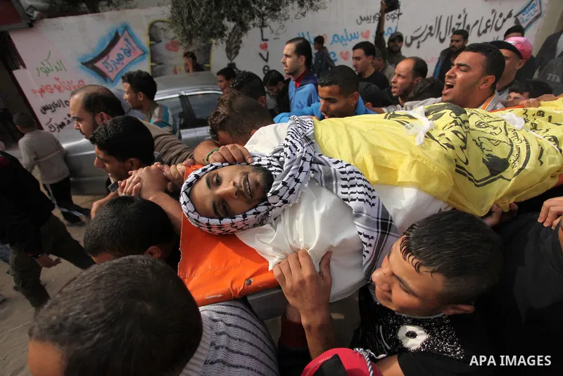 Mourners carry the body of Mohammed Abu Saada, a 26-year-old Palestinian man who was reportedly killed in clashes with the Israeli army along the Gaza border, during his funeral in the Nuseirat refugee camp in the centra...