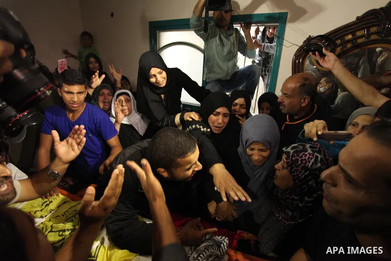Relatives of Mohammed Abu Saada, a 26-year-old Palestinian man who was reportedly killed in clashes with the Israeli army along the Gaza border, mourn during his funeral in the Nuseirat refugee camp in the central Gaza S...