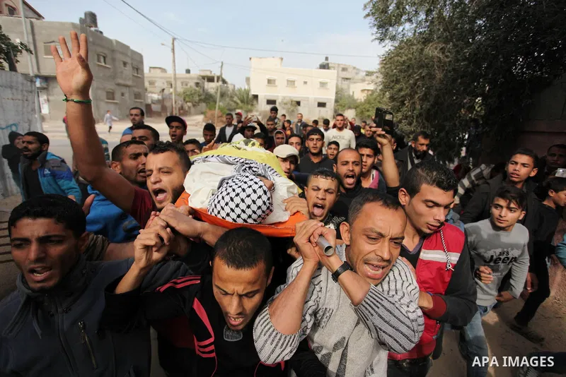 Mourners carry the body of Mohammed Abu Saada, a 26-year-old Palestinian man who was reportedly killed in clashes with the Israeli army along the Gaza border, during his funeral in the Nuseirat refugee camp in the centra...
