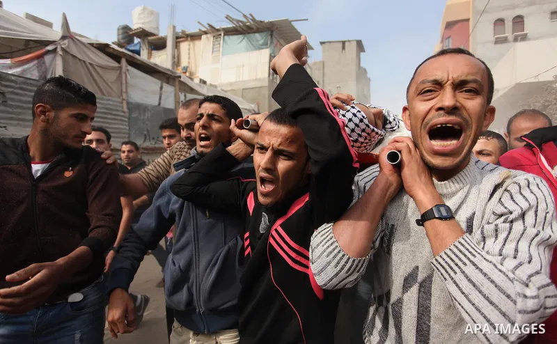 Mourners carry the body of Mohammed Abu Saada, a 26-year-old Palestinian man who was reportedly killed in clashes with the Israeli army along the Gaza border, during his funeral in the Nuseirat refugee camp in the centra...