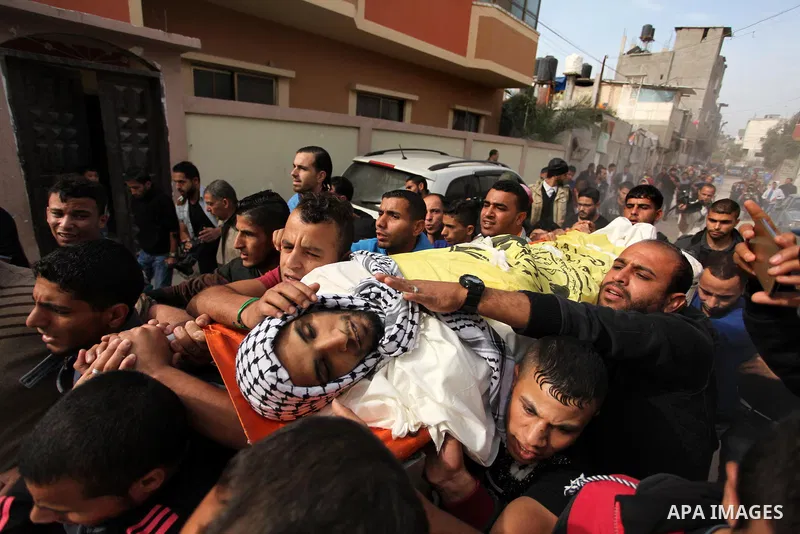 Mourners carry the body of Mohammed Abu Saada, a 26-year-old Palestinian man who was reportedly killed in clashes with the Israeli army along the Gaza border, during his funeral in the Nuseirat refugee camp in the centra...