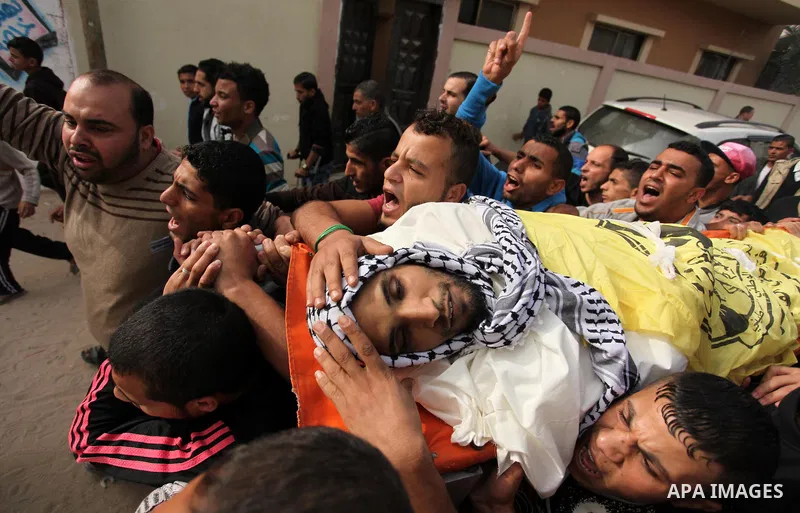 Mourners carry the body of Mohammed Abu Saada, a 26-year-old Palestinian man who was reportedly killed in clashes with the Israeli army along the Gaza border, during his funeral in the Nuseirat refugee camp in the centra...