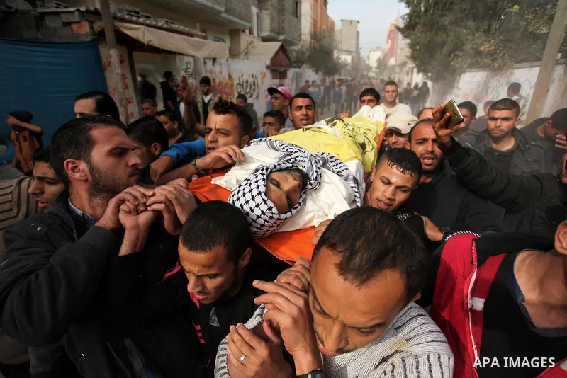 Mourners carry the body of Mohammed Abu Saada, a 26-year-old Palestinian man who was reportedly killed in clashes with the Israeli army along the Gaza border, during his funeral in the Nuseirat refugee camp in the centra...