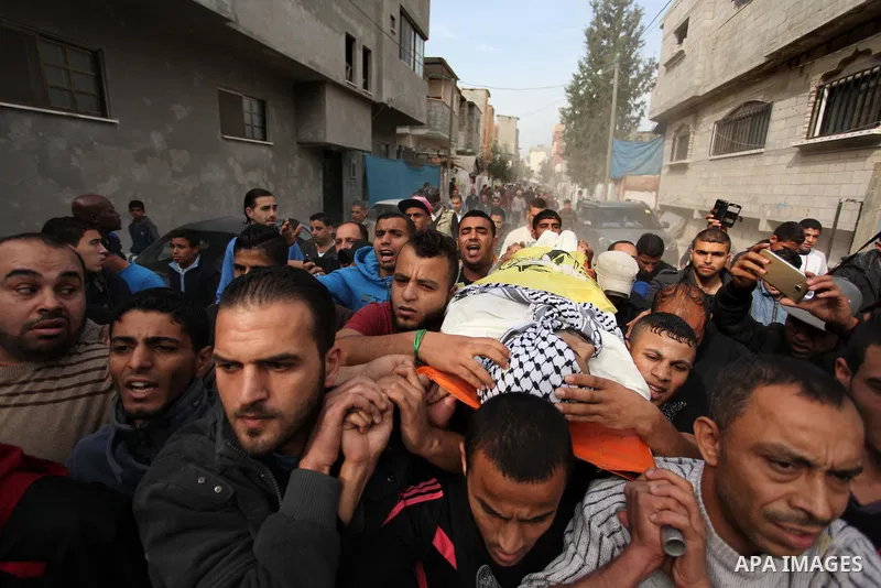 Mourners carry the body of Mohammed Abu Saada, a 26-year-old Palestinian man who was reportedly killed in clashes with the Israeli army along the Gaza border, during his funeral in the Nuseirat refugee camp in the centra...