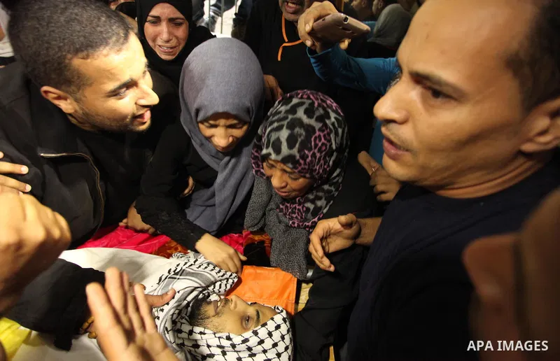 The Palestinian mother of Mohammed Abu Saada, a 26-year-old Palestinian man who was reportedly killed in clashes with the Israeli army along the Gaza border, mourns during his funeral in the Nuseirat refugee camp in the...