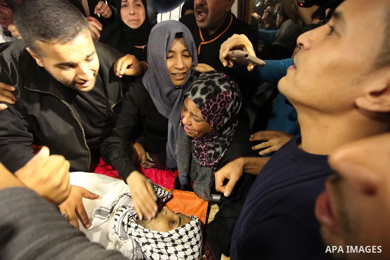 The Palestinian mother of Mohammed Abu Saada, a 26-year-old Palestinian man who was reportedly killed in clashes with the Israeli army along the Gaza border, mourns during his funeral in the Nuseirat refugee camp in the...