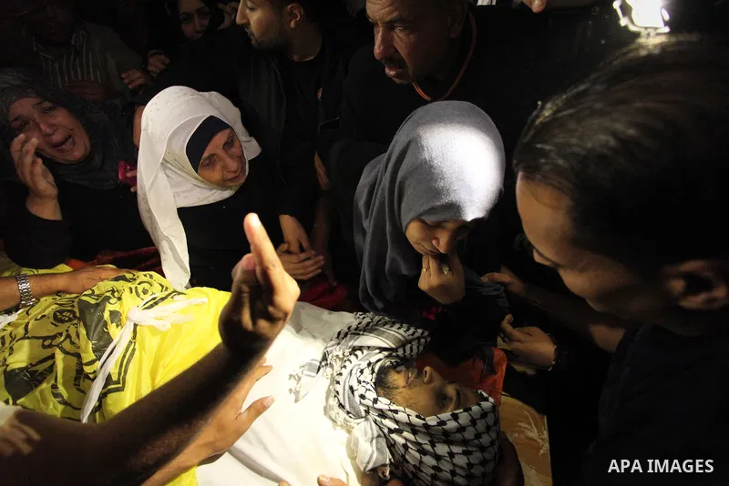 The Palestinian mother of Mohammed Abu Saada, a 26-year-old Palestinian man who was reportedly killed in clashes with the Israeli army along the Gaza border, mourns during his funeral in the Nuseirat refugee camp in the...