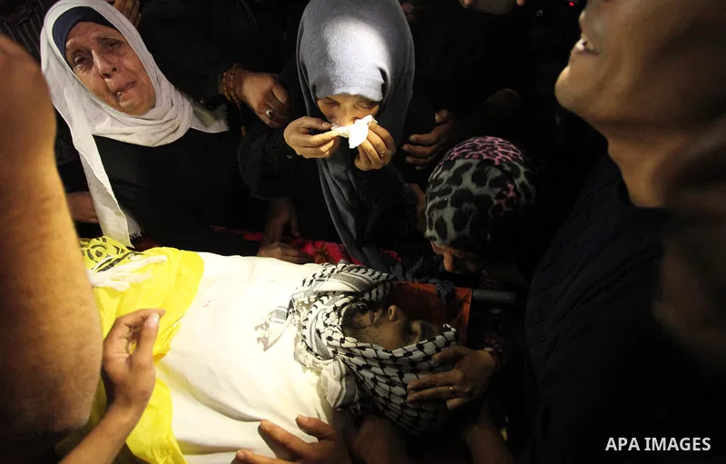 The Palestinian mother of Mohammed Abu Saada, a 26-year-old Palestinian man who was reportedly killed in clashes with the Israeli army along the Gaza border, mourns during his funeral in the Nuseirat refugee camp in the...