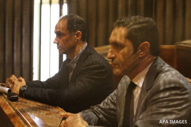 Alaa and Gamal Mubarak, the sons of former former president Hosni Mubarak sit in a courtroom cage during their trial on November 19, 2016. Cairo Criminal Court held at Police Academy adjourned Gamal and Alaa Mubarak tria...
