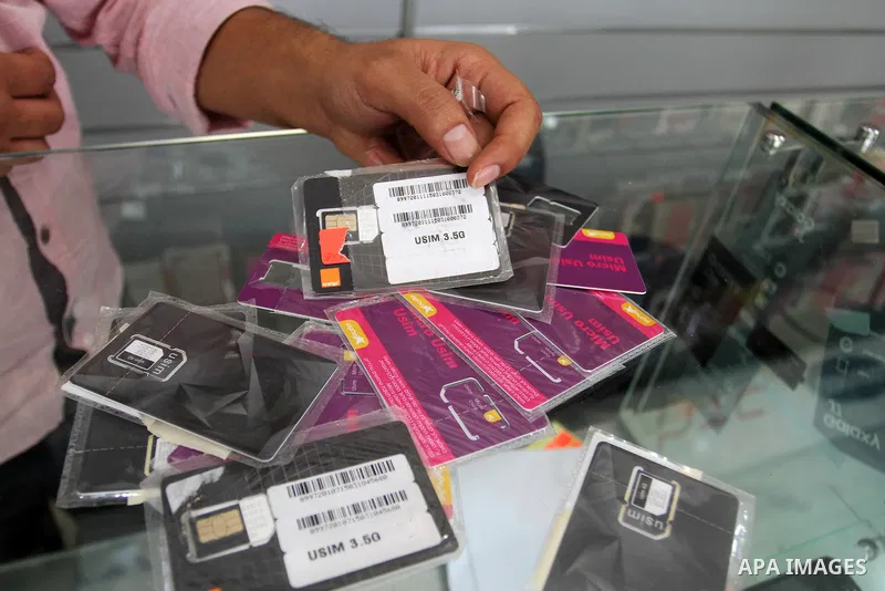 A Palestinian man displays SIM cards of Cellcom and Partner from Israeli cellular providers, in a mobile phone shop in Rafah in the southern Gaza strip, on November 20, 2016. Interior Ministry in Gaza are trying to stop...