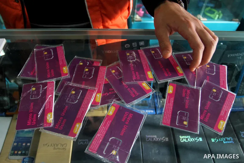 A Palestinian man displays SIM cards of Cellcom and Partner from Israeli cellular providers, in a mobile phone shop in Rafah in the southern Gaza strip, on November 20, 2016. Interior Ministry in Gaza are trying to stop...