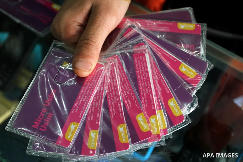 A Palestinian man displays SIM cards of Cellcom and Partner from Israeli cellular providers, in a mobile phone shop in Rafah in the southern Gaza strip, on November 20, 2016. Interior Ministry in Gaza are trying to stop...