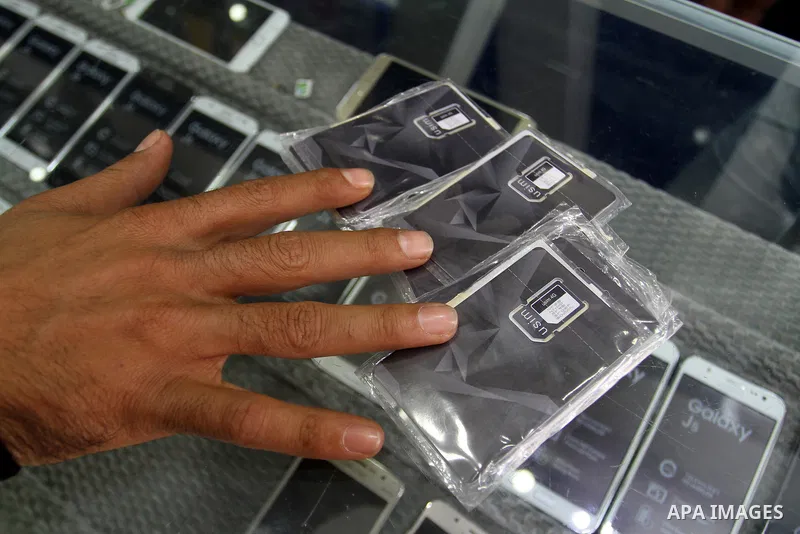 A Palestinian man displays SIM cards of Cellcom and Partner from Israeli cellular providers, in a mobile phone shop in Rafah in the southern Gaza strip, on November 20, 2016. Interior Ministry in Gaza are trying to stop...