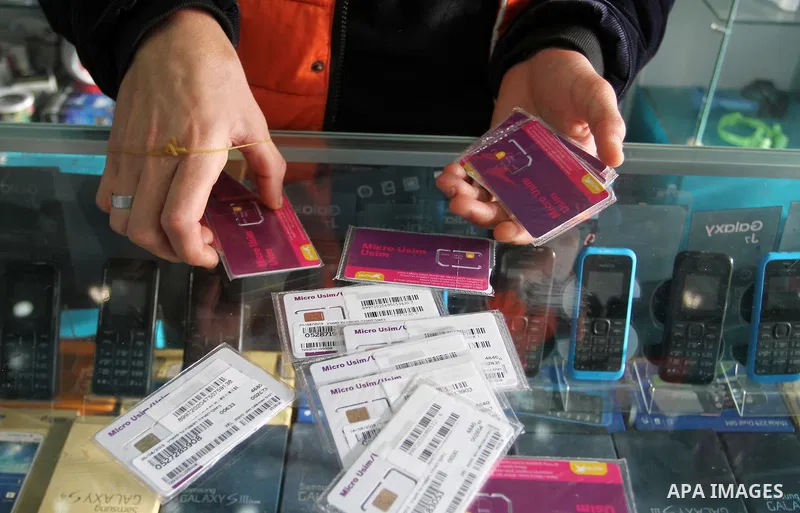 A Palestinian man displays SIM cards of Cellcom and Partner from Israeli cellular providers, in a mobile phone shop in Rafah in the southern Gaza strip, on November 20, 2016. Interior Ministry in Gaza are trying to stop...