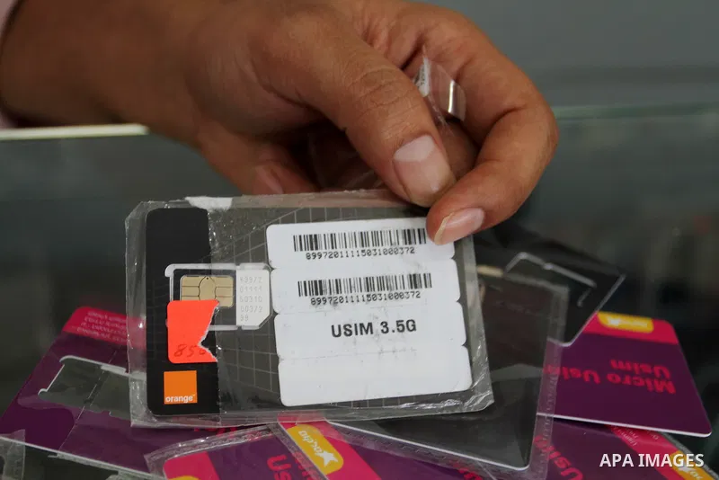 A Palestinian man displays SIM cards of Cellcom and Partner from Israeli cellular providers, in a mobile phone shop in Rafah in the southern Gaza strip, on November 20, 2016. Interior Ministry in Gaza are trying to stop...