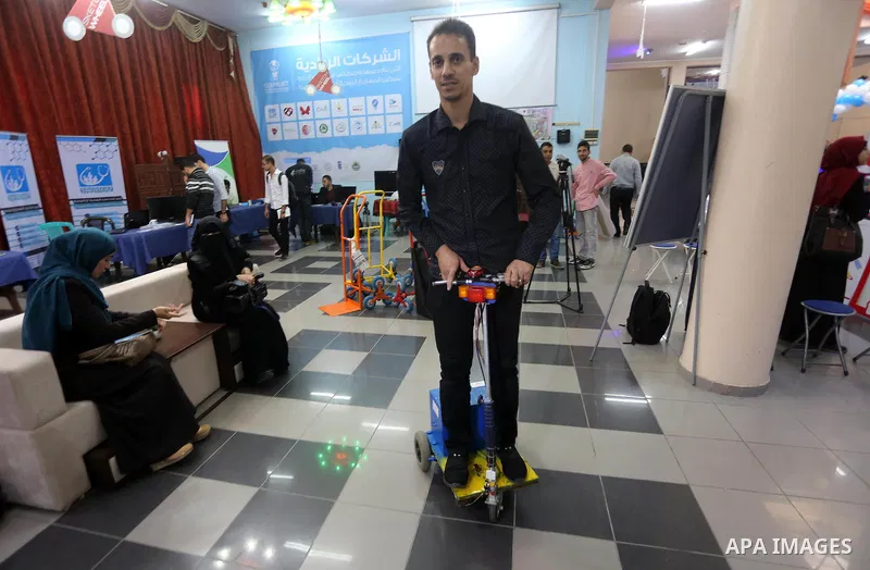 Palestinians take part during technology exhibition funded by Islamic Development Bank in Jeddah, at the Islamic University in Gaza city, on Nov. 20, 2016. Photo by Mohammed Asad