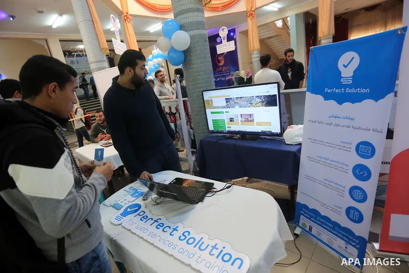 Palestinians take part during technology exhibition funded by Islamic Development Bank in Jeddah, at the Islamic University in Gaza city, on Nov. 20, 2016. Photo by Mohammed Asad