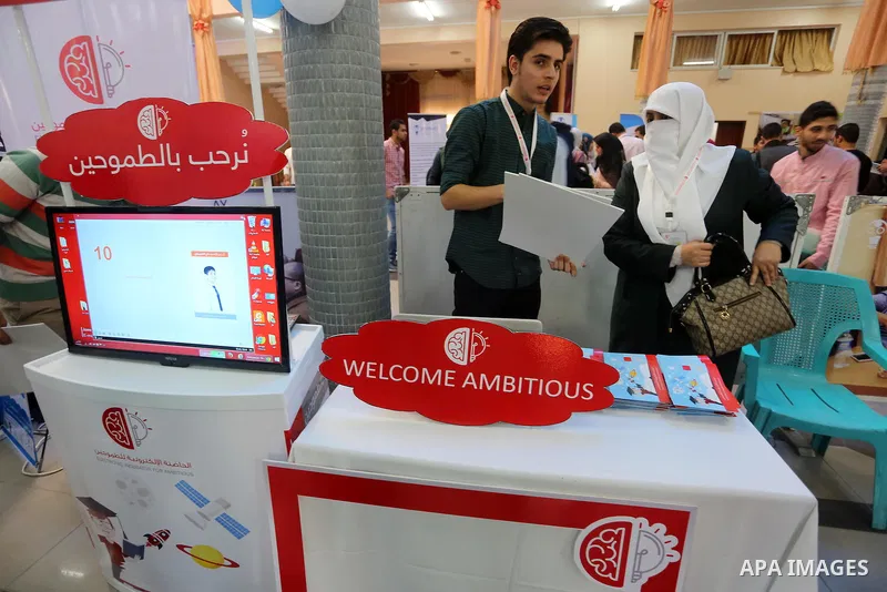 Palestinians take part during technology exhibition funded by Islamic Development Bank in Jeddah, at the Islamic University in Gaza city, on Nov. 20, 2016. Photo by Mohammed Asad