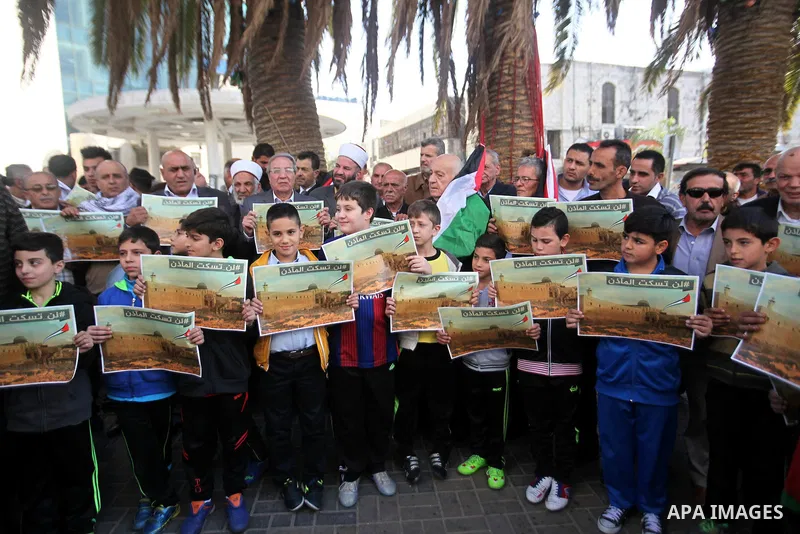 Palestinians hold banners during a protest against a controversial Israeli bill to limit the volume of calls to prayer at mosques in the occupied Jerusalem, in the West Bank city of Nablus on Nov. 20, 2016. Israeli Prime...
