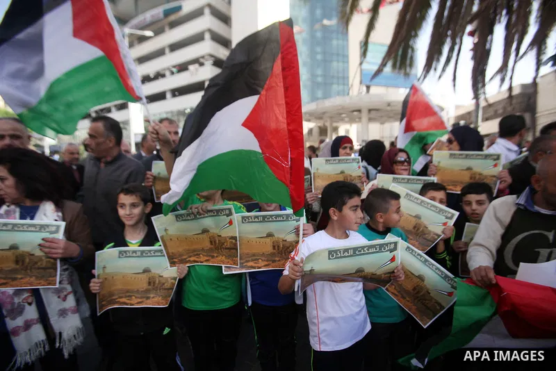 Palestinians hold banners during a protest against a controversial Israeli bill to limit the volume of calls to prayer at mosques in the occupied Jerusalem, in the West Bank city of Nablus on Nov. 20, 2016. Israeli Prime...