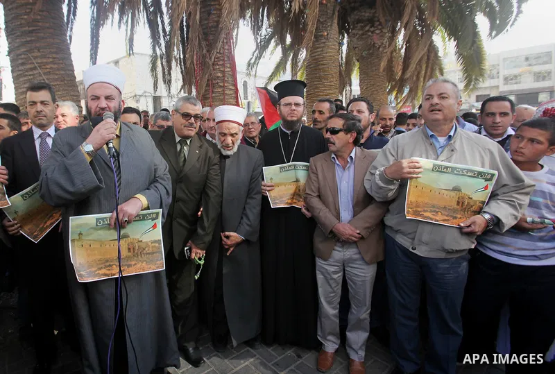 Palestinians hold banners during a protest against a controversial Israeli bill to limit the volume of calls to prayer at mosques in the occupied Jerusalem, in the West Bank city of Nablus on Nov. 20, 2016. Israeli Prime...