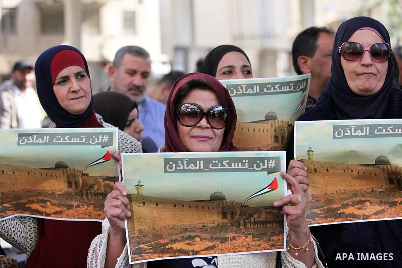 Palestinians hold banners during a protest against a controversial Israeli bill to limit the volume of calls to prayer at mosques in the occupied Jerusalem, in the West Bank city of Nablus on Nov. 20, 2016. Israeli Prime...