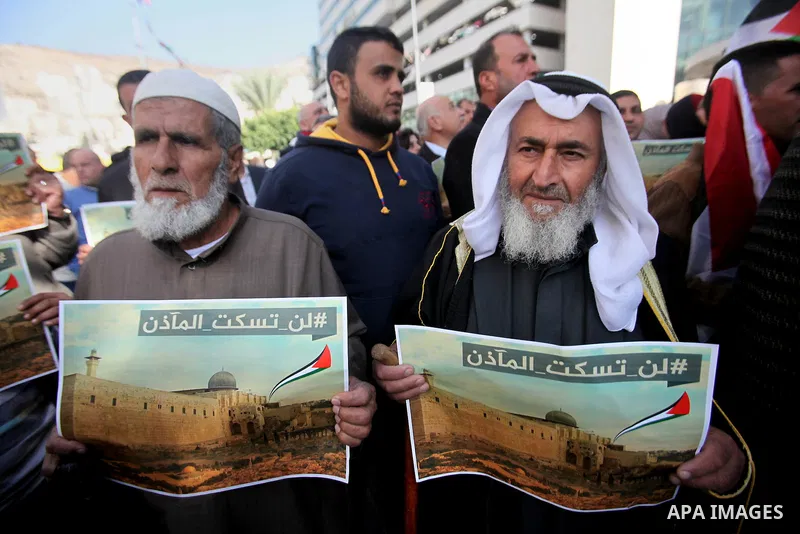 Palestinians hold banners during a protest against a controversial Israeli bill to limit the volume of calls to prayer at mosques in the occupied Jerusalem, in the West Bank city of Nablus on Nov. 20, 2016. Israeli Prime...