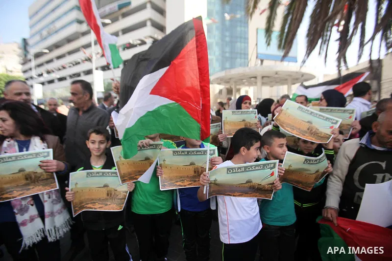 Palestinians hold banners during a protest against a controversial Israeli bill to limit the volume of calls to prayer at mosques in the occupied Jerusalem, in the West Bank city of Nablus on Nov. 20, 2016. Israeli Prime...