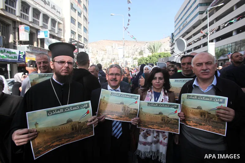 Palestinians hold banners during a protest against a controversial Israeli bill to limit the volume of calls to prayer at mosques in the occupied Jerusalem, in the West Bank city of Nablus on Nov. 20, 2016. Israeli Prime...