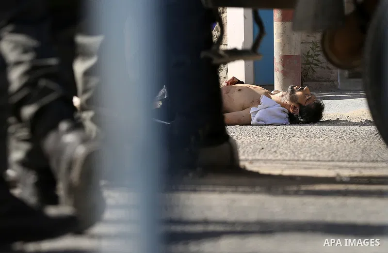 Israeli security forces gather at the site where a Palestinian was shot dead after allegedly walking towards guards wielding a knife at the Qalandia checkpoint crossing between the West Bank city of Ramallah and Israeli-...