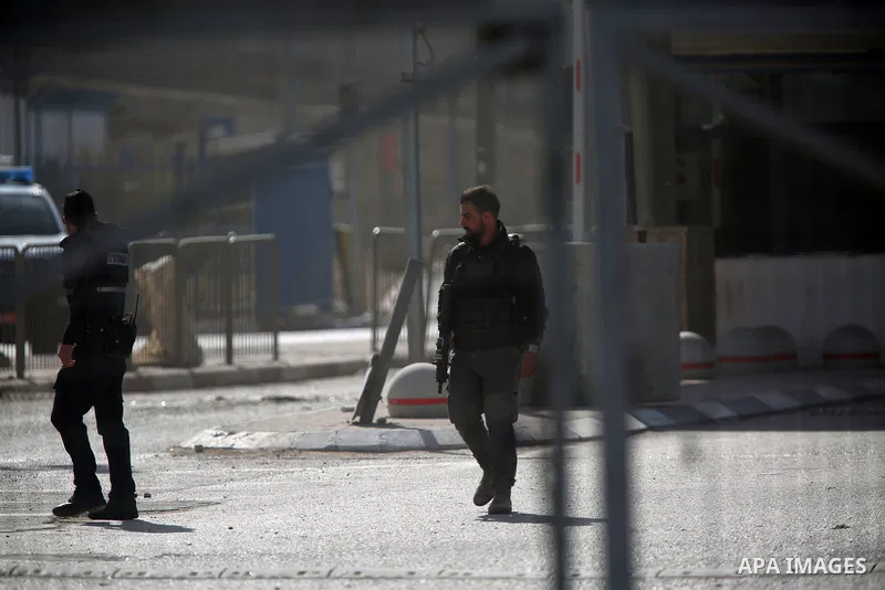Israeli security forces gather at the site where a Palestinian was shot dead after allegedly walking towards guards wielding a knife at the Qalandia checkpoint crossing between the West Bank city of Ramallah and Israeli-...