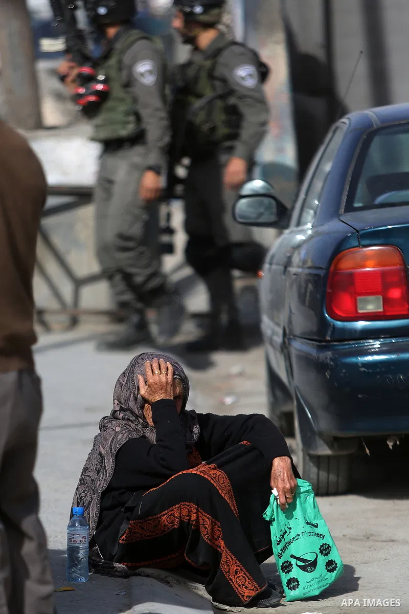 Israeli security forces gather at the site where a Palestinian was shot dead after allegedly walking towards guards wielding a knife at the Qalandia checkpoint crossing between the West Bank city of Ramallah and Israeli-...