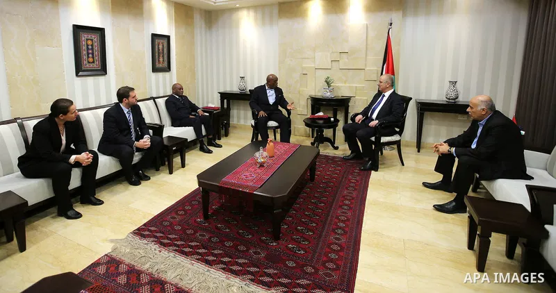 Palestinian Prime Minister Rami Hamdallah meets with Head of FIFA's monitoring mission on the Israel-Palestinian issue of football, South Africa's Tokyo Sexwale, in the West Bank city of Ramallah on Nov. 22, 2016. Photo...