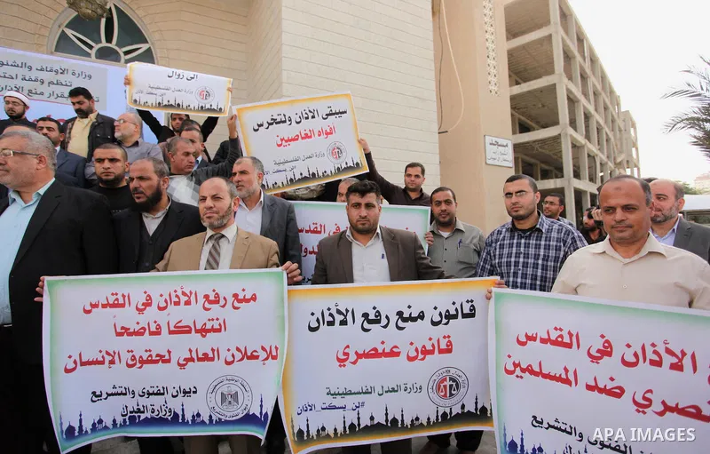 Palestinians hold banners during a protest against a controversial Israeli bill to limit the volume of calls to prayer at mosques in the occupied Jerusalem, in Gaza city on November 23, 2016. Israeli Prime Minister Benja...